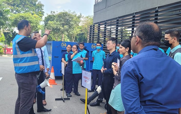 Employees at Pan Pacific Serviced Suites Beach Road participate in a fire evacuation exercise.